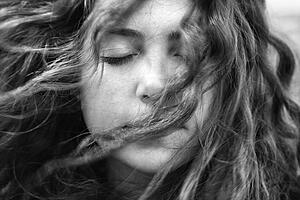 Female with hair blowing in face