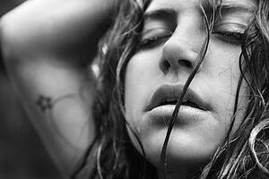 Young adult woman with disheveled hair and closed eyes