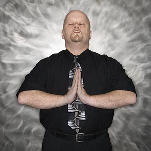 Bald man standing in a meditative position