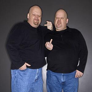 Bald mid adult identical twin men making obscene gesture at viewer.