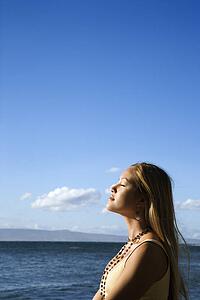 Young adult female standing on beach 