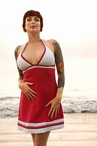 Tattooed woman on beach 