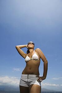 Woman standing on beach in bikini