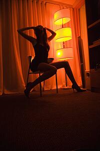Woman sitting in chair floor lamp