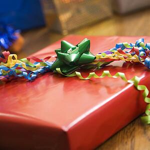 Presents wrapped and decorated with bows on a table.