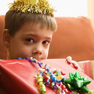 Boy holding gift up to face