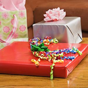 Presents wrapped and decorated with bows on a table.