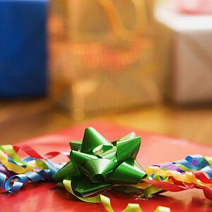 Presents wrapped and decorated with bows on a table.