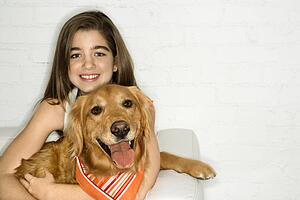 Female holding Golden Retriever dog