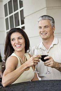Couple toasting sitting at table