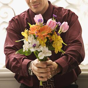 Man holding bouquet of flowers