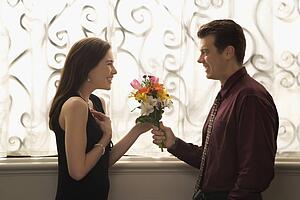 Man surprised woman with bouquet
