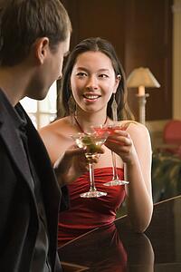 Woman and man toasting martinis