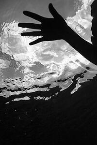 Female hand pressing on water