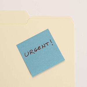 Folder with a sticky note attached reading urgent