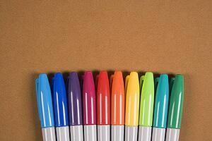 Group of colorful markers lined up in a row