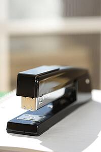 Black stapler with window in background