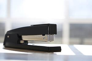 Black stapler with window in background