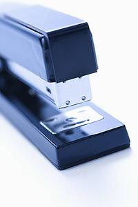 Blue stapler on white background.