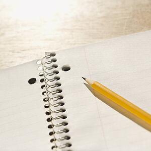 Pencil on top of spiral bound notebook.