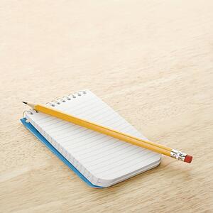 Pencil on top of open spiral bound notepad