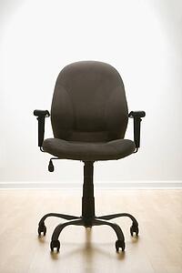 Still life of empty office desk chair