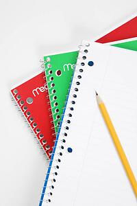 Pencil on top of three spiral bound notebooks