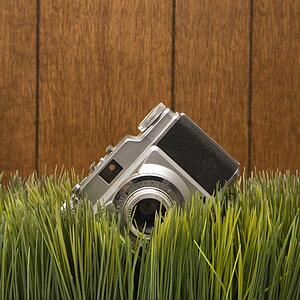 Studio shot of vintage camera with wood paneling in background