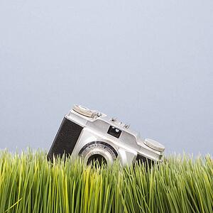 Studio shot of vintage camera in grass
