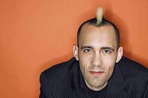 Man with mohawk wearing suit