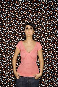Female standing with hands in pockets 