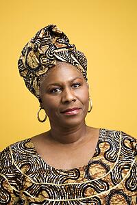African American mature adult female dressed in African costume.