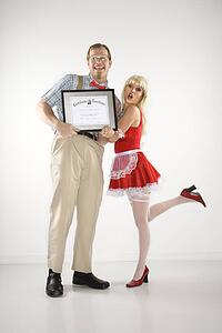 Man dressed like nerd holding certificate with woman dressed in french maid outfit