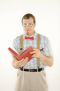 Man dressed like nerd with book open 
