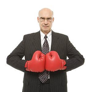 Businessman wearing boxing gloves.