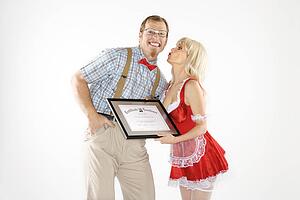 Man dressed like nerd receiving kiss and certificate from woman dressed in french maid outfit