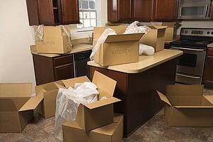 Cardboard moving boxes with bubble wrap in kitchen