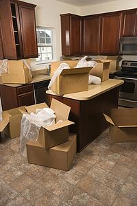 Cardboard moving boxes with bubble wrap in kitchen