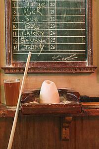 Chalkboard queue for people waiting to play billiards
