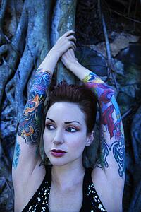 Blue-toned portrait of tattooed woman with Banyan tree 