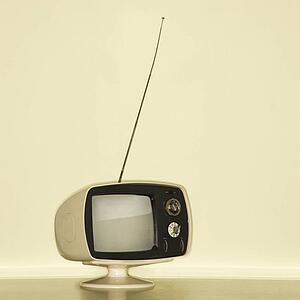 Still life of vintage television set with antenna raised.