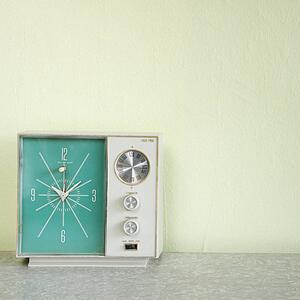 Still life of vintage clock radio with turquois face.