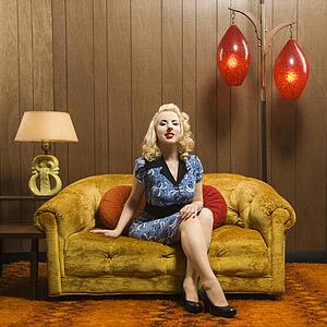 Woman sitting in retro decorated room