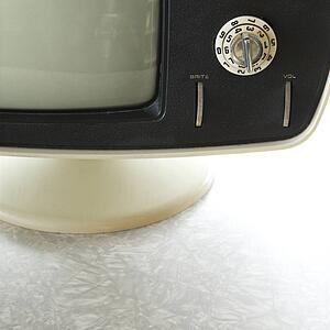 Close-up still life of vintage television set with adjustment knob.