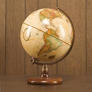 Still life shot of a vintage world globe sitting on a desk