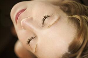 Close up portrait of pretty redhead woman with eyes closed