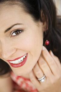 Close-up of mid-adult Caucasian woman wearing wedding ring.