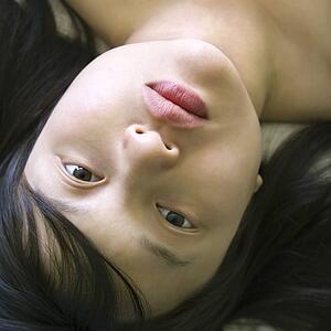 Woman lying in bed making eye contact
