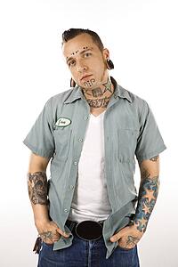 Man with tattoos and piercings