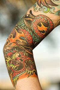Dragon tattoo on arm of woman